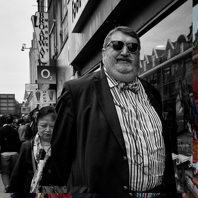 Man walking down Tooting High Street, South London black-and-white photography