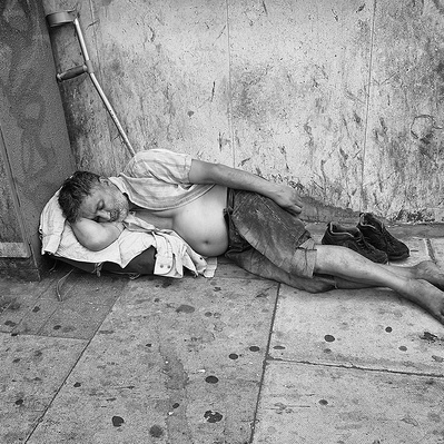 Rough sleeper sleeping on floor London black-and-white photography