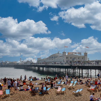 A photo of Brighton pierre with people on the beach, Sussex, England, photography