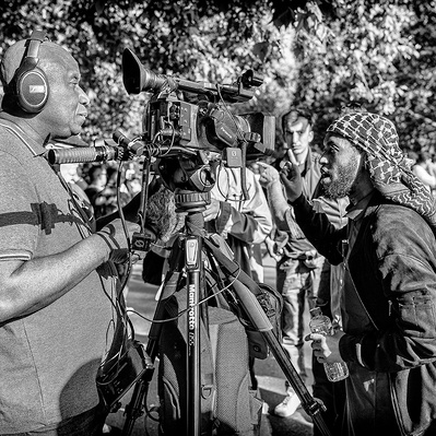 Man being interviewed at speakers corner London black-and-white photography