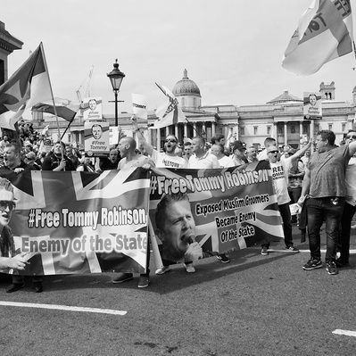 'Tommy Robinson Protestests Waving Flags in Trafalgar Square, London Black and White Street Photography'