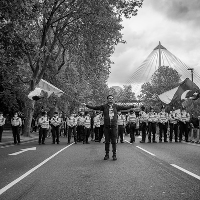 'Pro Palestinian supporter holding flags, Embankment, London Street Photography Black and White'
