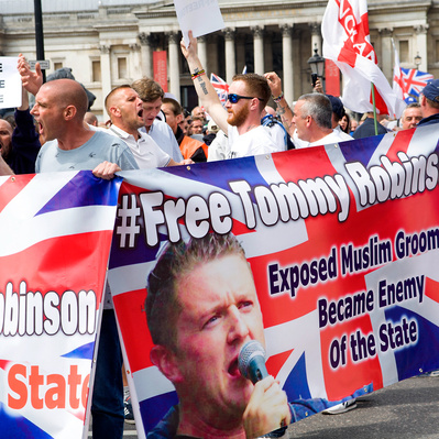 'Tommy Robinson Protesters Waving In Flags in Trafalgar Square, London Colour Street Photography'