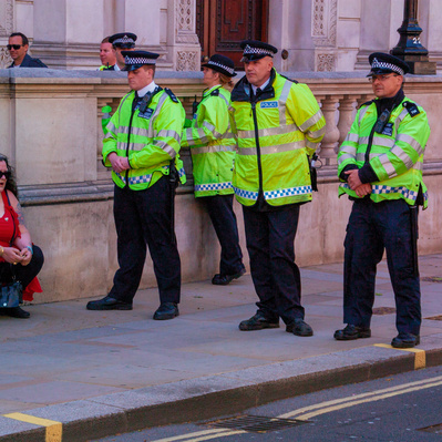 'Met Police Officers surround an EDL woman protester, London Colour Street Photography'