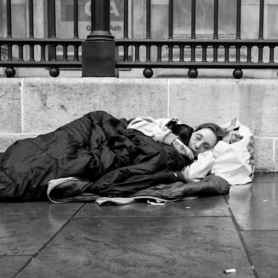 Woman trying to keep warm London black-and-white photography 