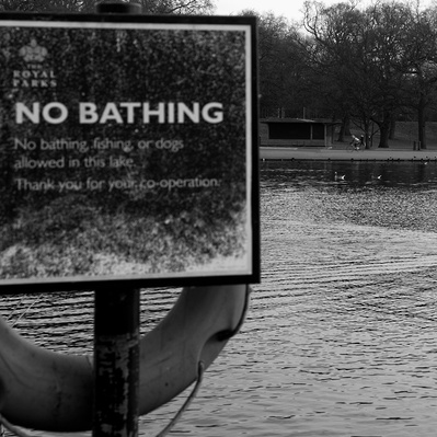 'No bathing sign woman in background swimming, Black & White London Street Photography'