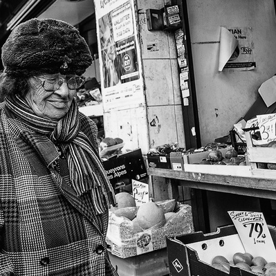 'Old lady waking past fruit and veg shop, Black & White London Street Photography'