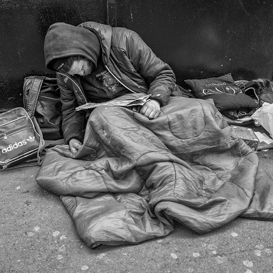 Rough sleeper resting up London black-and-white photography