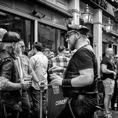Group of men standing outside pub having a chat Soho London black-and-white photography