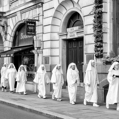 A group of Druids walking down the road London black-and-white photography