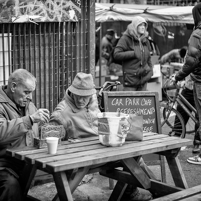 Two men haggling over a price East End market London black-and-white photography