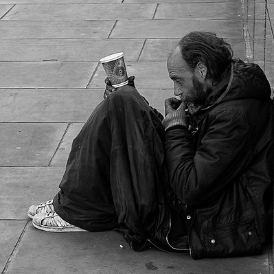 Rough sleeper, hoping for some money, London black-and-white photography