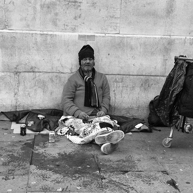 Homeless man sitting down relaxing London black-and-white photography