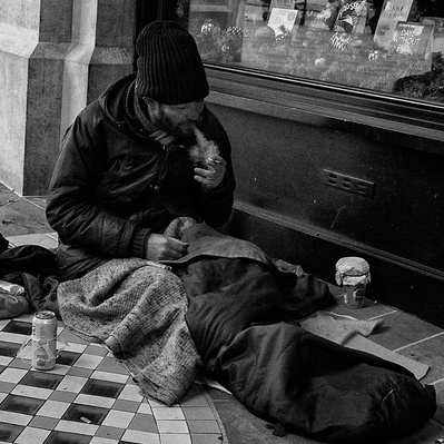 Rough sleeper having a smoke in London black-and-white photography