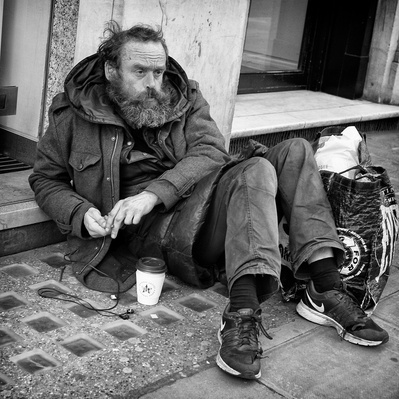A rough sleeper in deep default London black-and-white photography