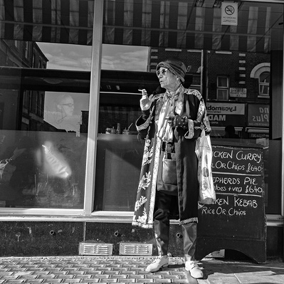 'Woman dressed in eccentric clothing smoking, Black & White London Street Photography'