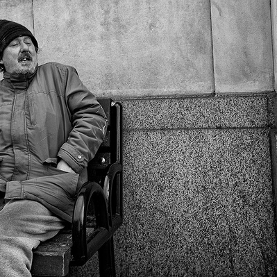 Rough sleeper singing and happy London black-and-white photography