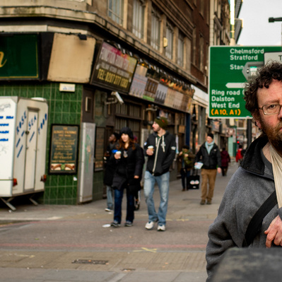 'Man has his arm in a sling near Petty Coat Lane, London Street Photography Colour'
