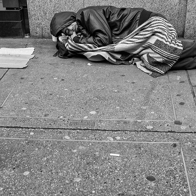 Rough sleeper sleeping on the ground London black-and-white photography