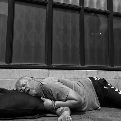 A man sleeping on his bag, London black-and-white photograph photography