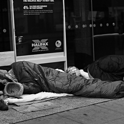 Two rough sleepers sleeping in the doorway, London black-and-white photography