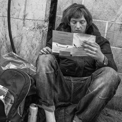 Too rough sleepers sitting outside tooting Broadway underground station London black-and-white photograph photography
