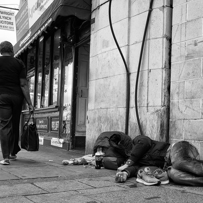 Homeless man sleeping on the streets, Tooting South London black-and-white photography