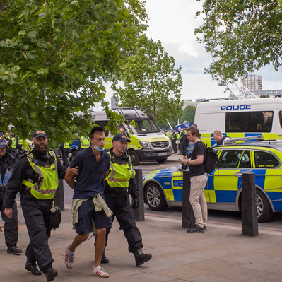 'Met Police walk away an arrested protester at the Black Lives Matter protests, London Colour Street Photography'