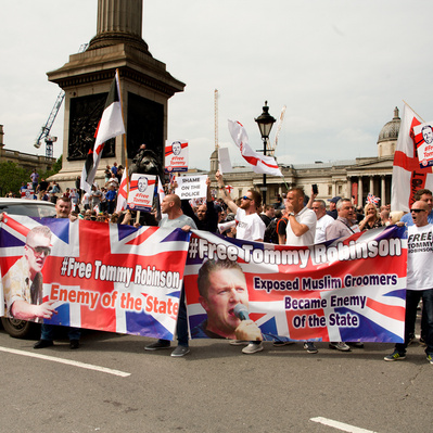 'Tommy Robinson Supporter stopping traffic in Trafalgar Square, London colour Street Photography'