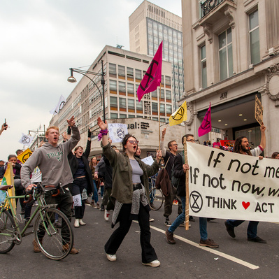 'Protesters march along Oxford Street at the Extinction Rebellion Protests, London Colour Street Photography'