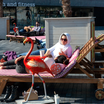 'Woman sits on a sun lounger next to the river thames , London Street Photography Colour'