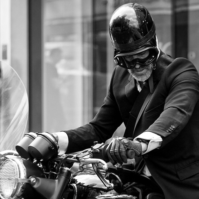 A City gent on his motorcycle, London black-and-white photograph photography