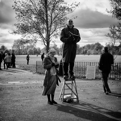 A preacher standing on his step ladders, preaching speakers corner, London black-and-white photography