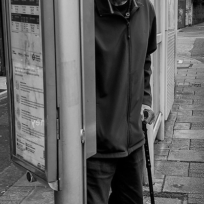 Elderly man waiting for a bus Tooting South London black-and-white photography