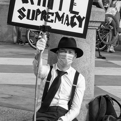 'Man Sitting Down Holding a Placard at the Black Lives Matter Protests, London Black and White Street Photography'