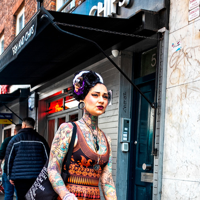 Tattooed lady walking along old Compton Street Soho colour photography