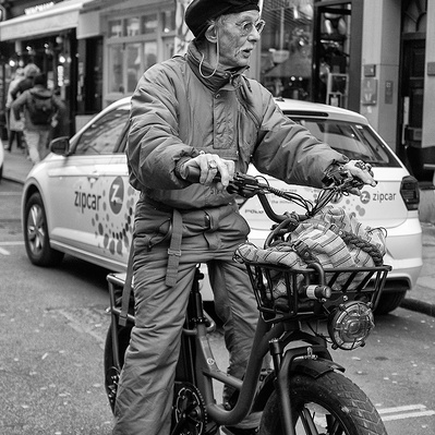 A man on a pushbike, Soho, London black-and-white for photography