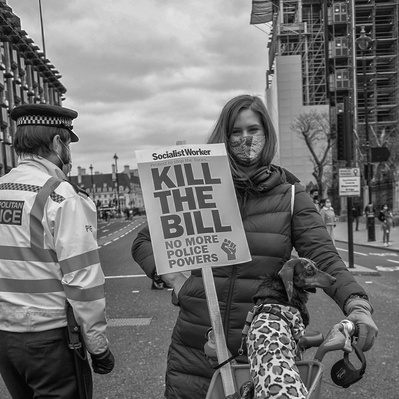 'Kill the Bill supporter outside Parliament With her dog , London. Street Photography Black and White'