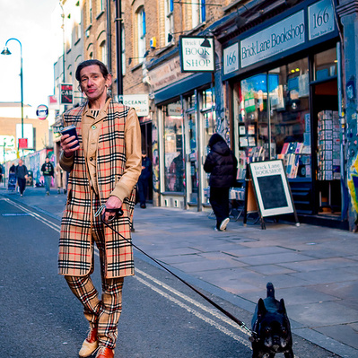 I stylish man and his dog brick lane East London colour photography