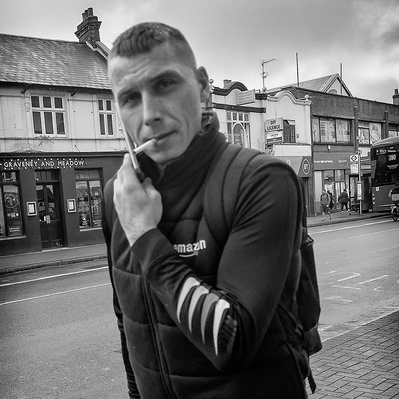 A man in a hurry, Tooting High Street, south London black-and-white photography