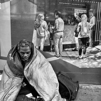 A rough sleeper wrapped around his sleeping bag, London black-and-white photography