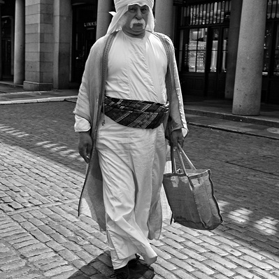 'Man dressed in arabic robes walking through covent garden, Black & White London Street Photography'
