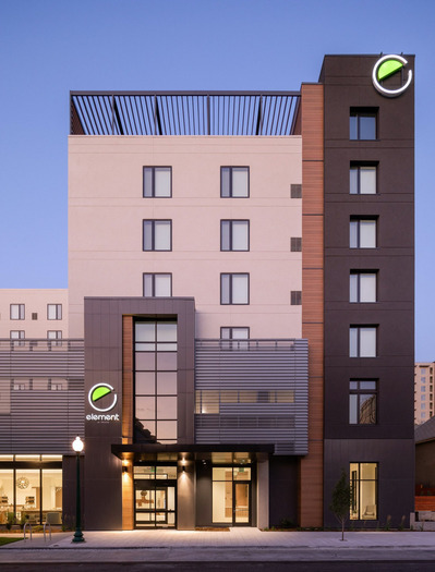 Exterior front of Element Marriott Denver, highlighting the hotel's modern architecture and the glowing lights at dusk.