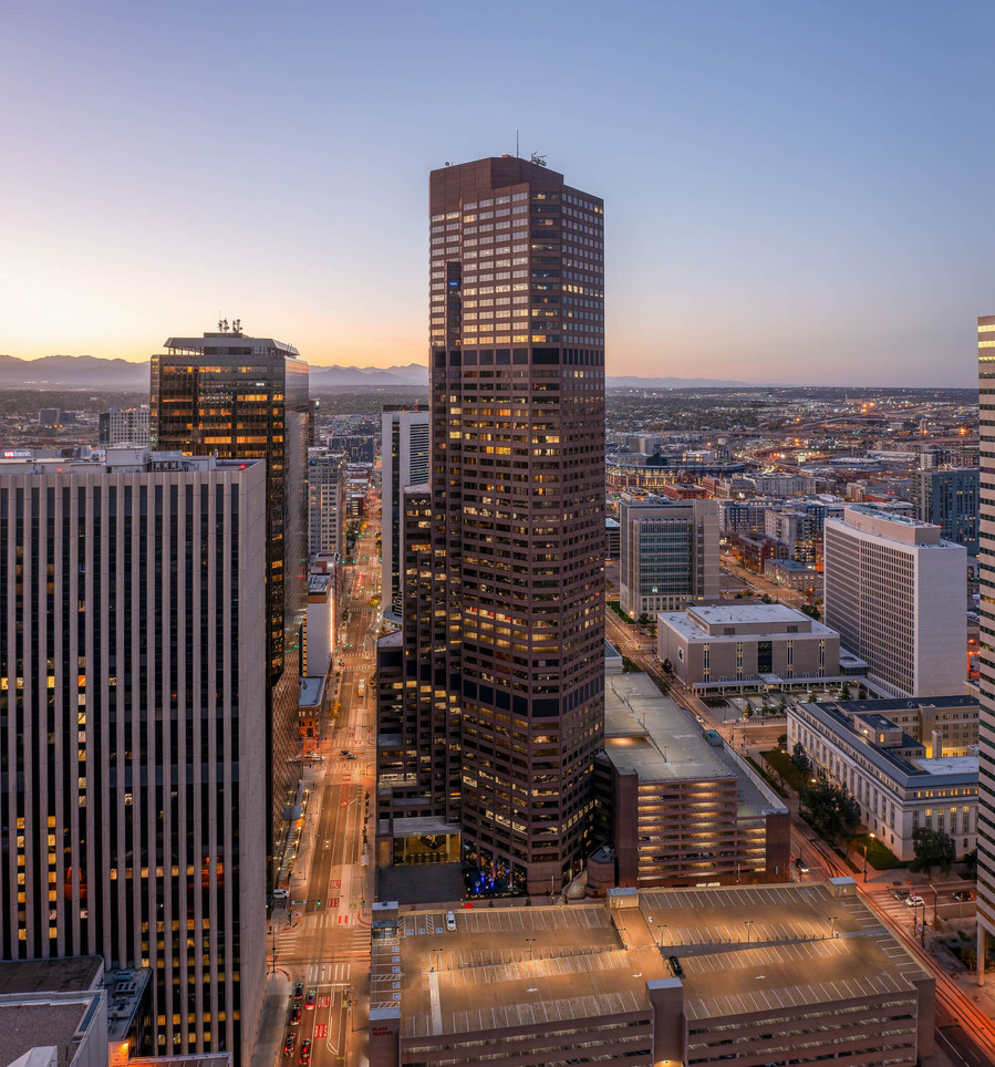 A large sky scrapper in Denver at twilight.