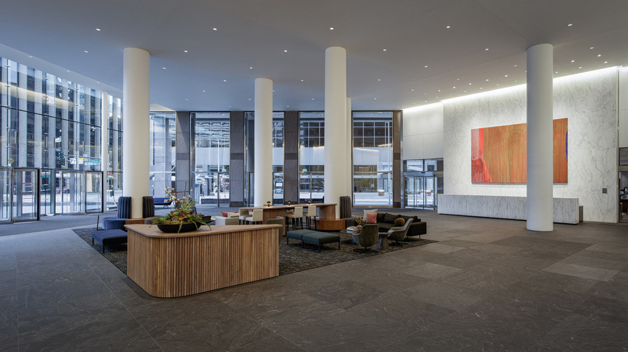 Large modern lobby with huge art piece over the front desk.