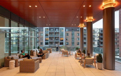 The terrace patio at Kimpton Claret Hotel in Denver, offering views of the city in a stylish outdoor space.