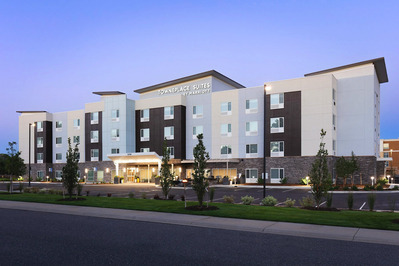 Exterior of TownePlace Suites Marriott in Denver at twilight, highlighting the hotel’s architecture and lighting.
