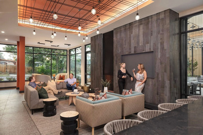 Modern lobby with two men on the sofa talking and two ladies sharing a drink.
