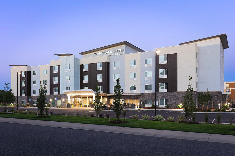 Exterior of TownePlace Suites Marriott in Denver at twilight, highlighting the hotel’s architecture and lighting.