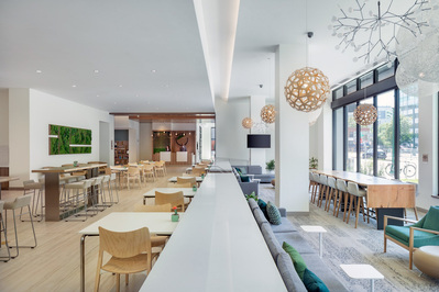 Seating and dining area in the lobby of Element Marriott Denver, featuring sleek and functional design.